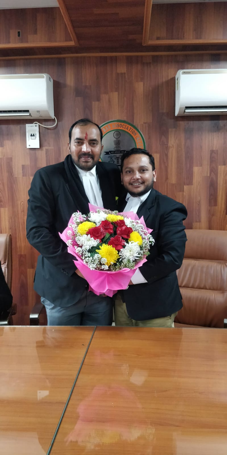Advocates in court robes at a Bar Association felicitation