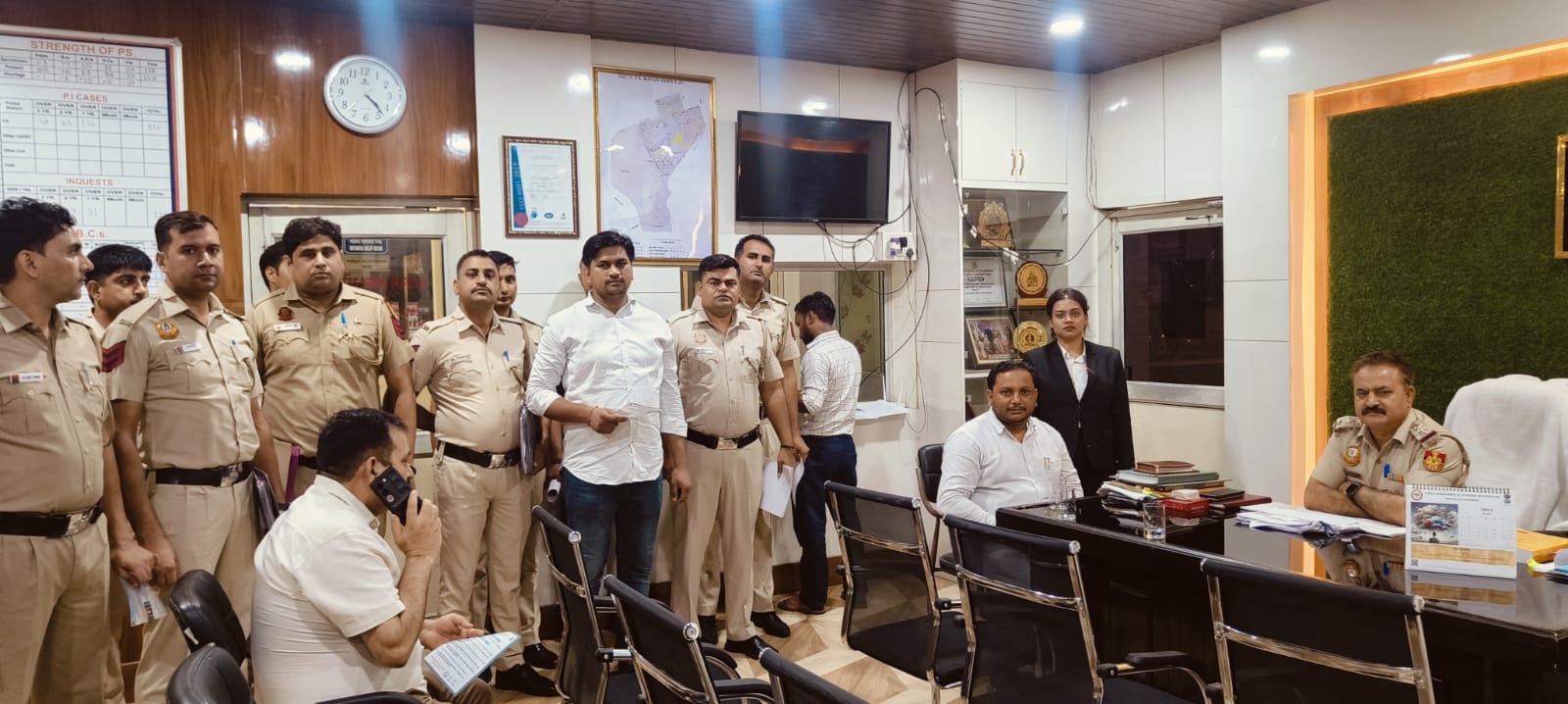 Advocate in conference with police officers at a station house